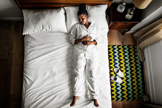 Woman in bed sleeping peacefully on her back 